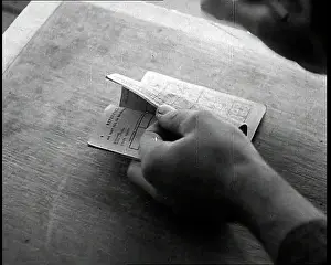 Someone: Someone Checking a Ration Book