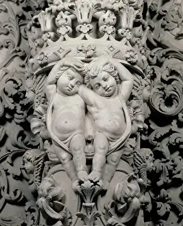 Lecce: Two cherubs embracing. Close-up of