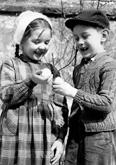 Chidren: Chidren tapping eggs at Easter. About 1960. Photograph