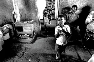 Migrate: A child with adults drinking beer in a shebeen