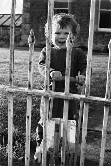 Child looking through railings