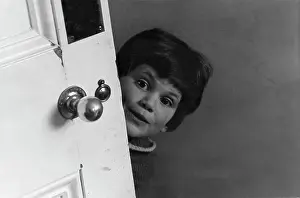Pops: Child looking round an open door
