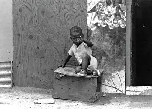 Focuses: A child outside his home in Soweto, 1993. Ruth