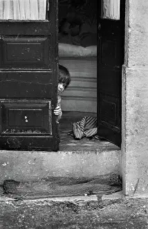 Peep: Child peeping round door, Lisbon