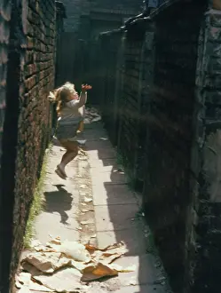 Alleyway: Child playing in an alleyway