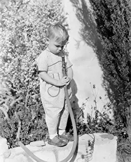 Wholesome: Child pointing hose at face
