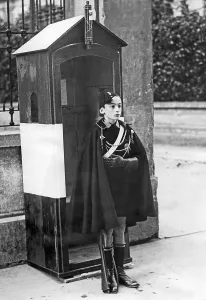Sentry: Child as a sentry in front of a driveway in Rome, 1930