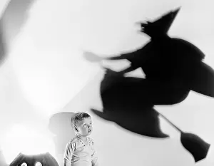 Spook: Child with silhouette of witch and jack o lantern