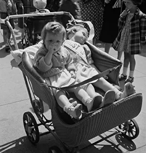 Stroller: Children in a baby stroller during a parade