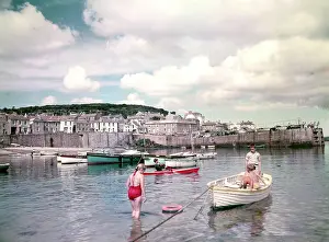 Mousehole: Children and boats in Mousehole Harbour, Cornwall