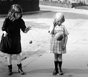 Bouncing: Children bouncing balls, early 1900s