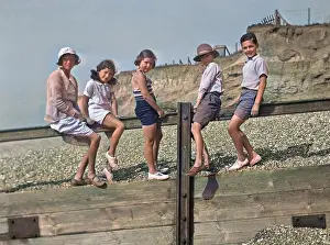 Breakwater: Five children on a breakwater at the seaside