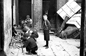 Kindling: Children chopping wood to make kindling, Smithfield, London