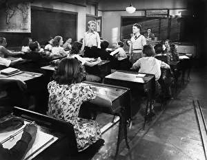 Academia: Children in a class room with a teacher and two