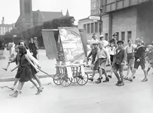 Sentences: Children at a communist propaganda campaign, circa 1920s