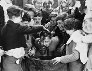 Crowding: Children crowded around apple bobbing