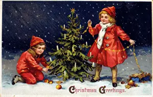 Decorating: Children decorating Christmas tree