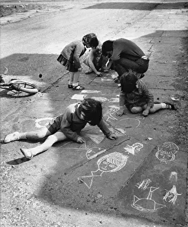 Slum: Children draw on pavement with chalk