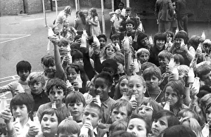 Discontinued: Children drinking milk in a playground, Woolwich, London