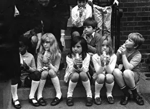 Discontinued: Children drinking milk in a playground, Woolwich, London