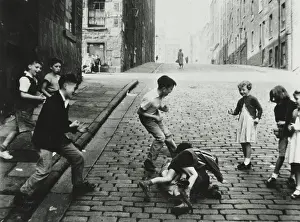 Playtime Nostalgia Photography: Children fighting in the roadway