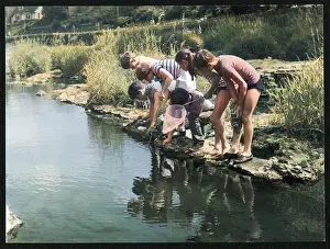CHILDREN FISH IN STREAM