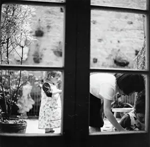 The John Krish Collection: Three children in a garden, seen through the window