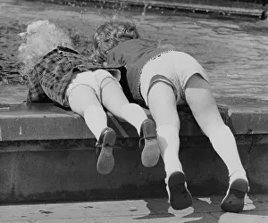 Backside: Children leaning over the edge of a pool