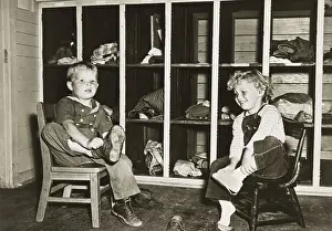 Daycare: Children take off their shoes before a nap in