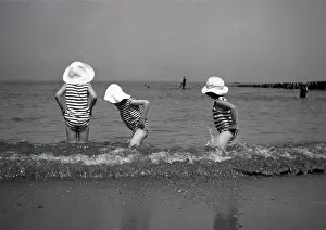 Sunhat: Three children paddling in the sea