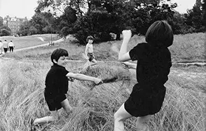 Bunched: Children play fighting in long grass