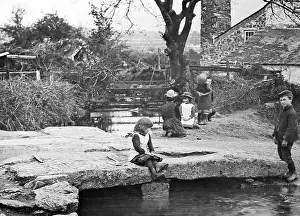 Dartmoor: Children playing on a clapper bridge on Dartmoor