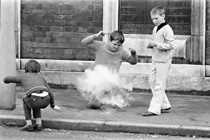 Children playing with fireworks in street