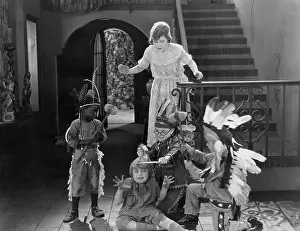 Wildness: Children playing indians with mother looking on