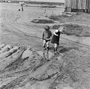 Puddles: Children Playing In Mud