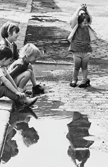 Children playing near a puddle
