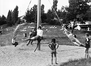 Carousel: Children playing at a playground, 1936