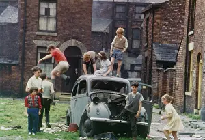 Wasteland: Children playing round an old car