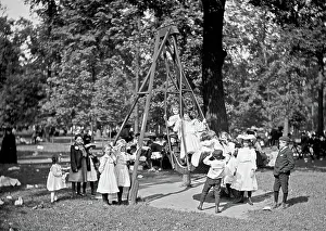 Swings: Children playing on the swings in a park playground in Ameri