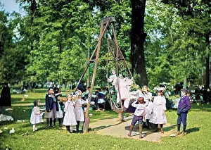 Swings: Children playing on the swings in a park playground in Ameri