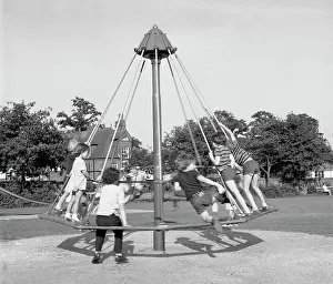 Roundabouts: Children playing on an umbrella roundabout