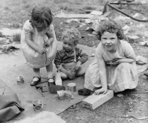Wasteland: Three children playing on waste ground