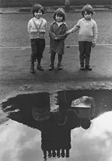 Puddle: Three children with reflective puddle