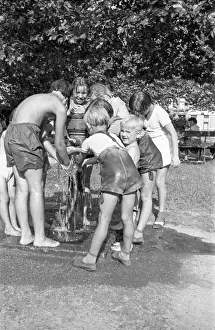 Refresh: Children refresh themselves at drinking fountain