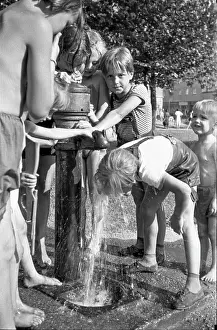Refresh: Children refresh themselves at drinking fountain