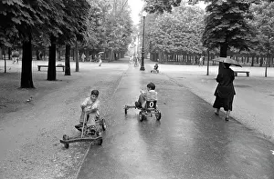 Oosterbroek: Children riding on go-carts along a tree-lined