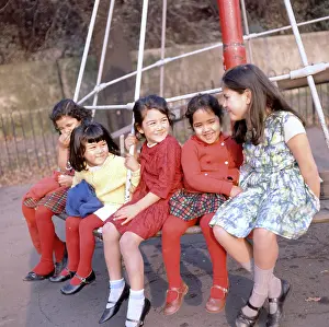Roundabout: Five children on a roundabout in a park