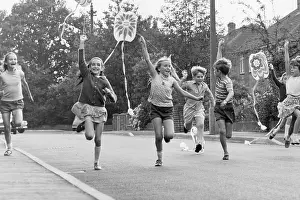 Horley: Children running along a street with their kites