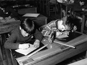 Pencils: CHILDREN AT SCHOOL DESKS