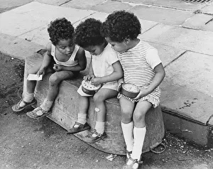 Upturned: Three children sitting on a tin bath